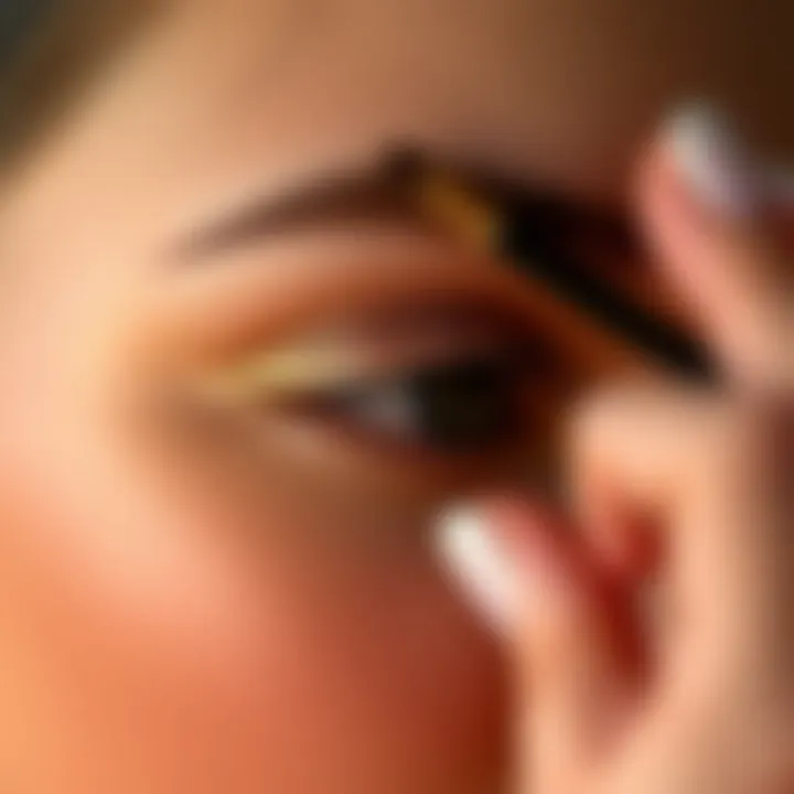 Application of shimmer gold eyeshadow on eyelids