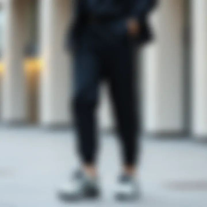 Fashionable outfit pairing black pants with side stripe and trendy footwear